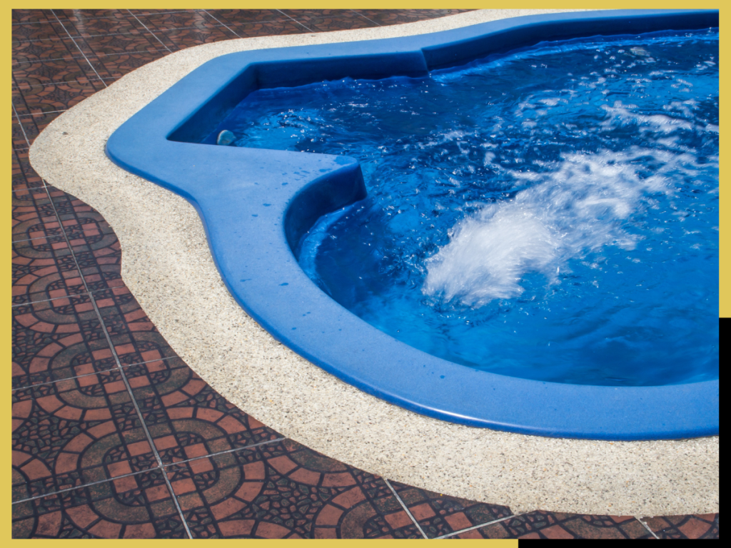 Custom in-ground jacuzzi with stone tile installed by El Vive in Montreux, Reno